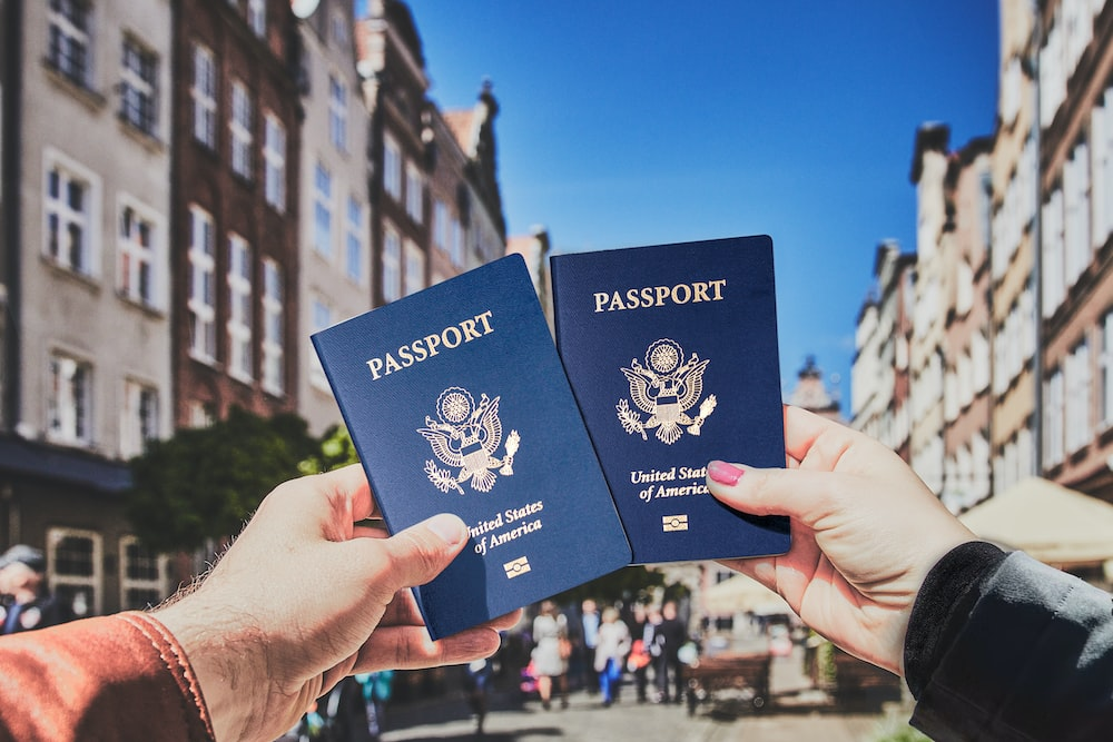 two people holding passports in their hands