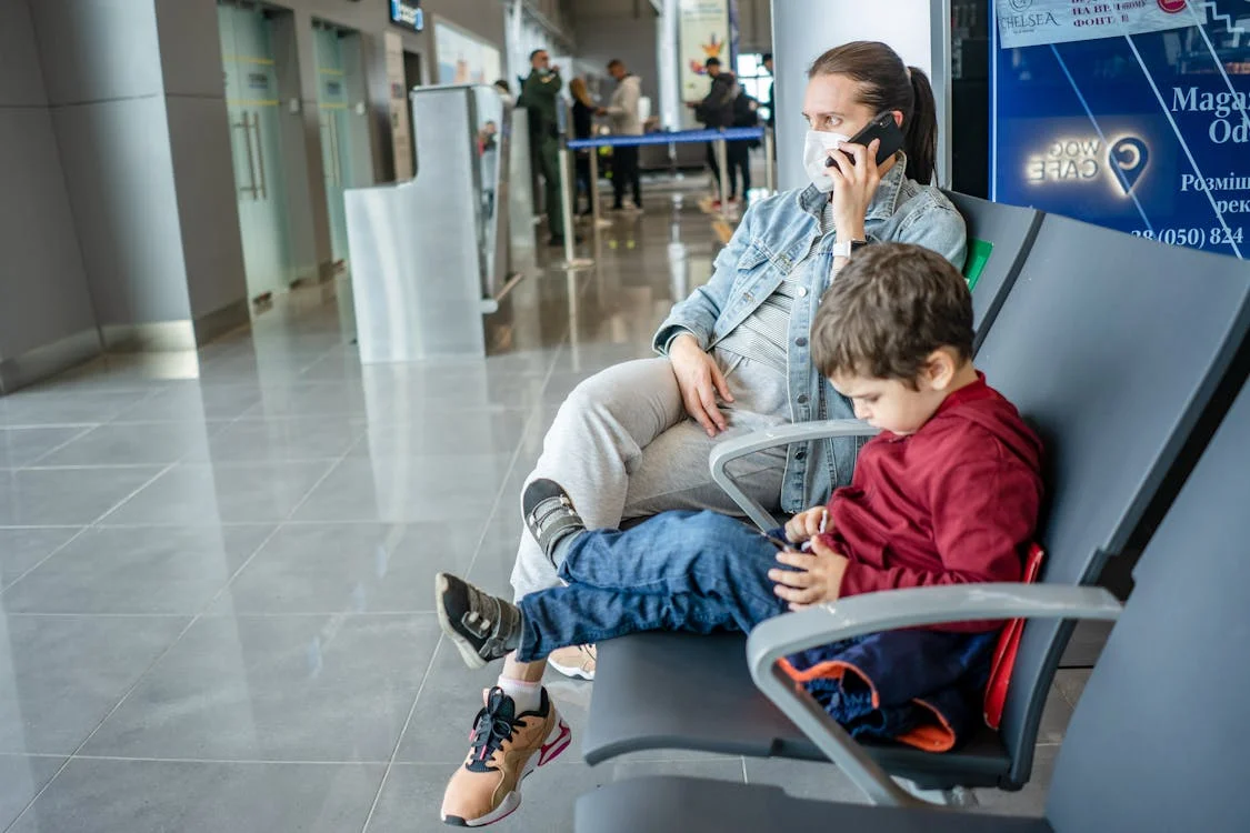 A mom and son waiting at the airport 