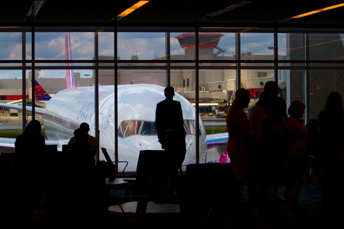 Silhouettes of people near an airplane 