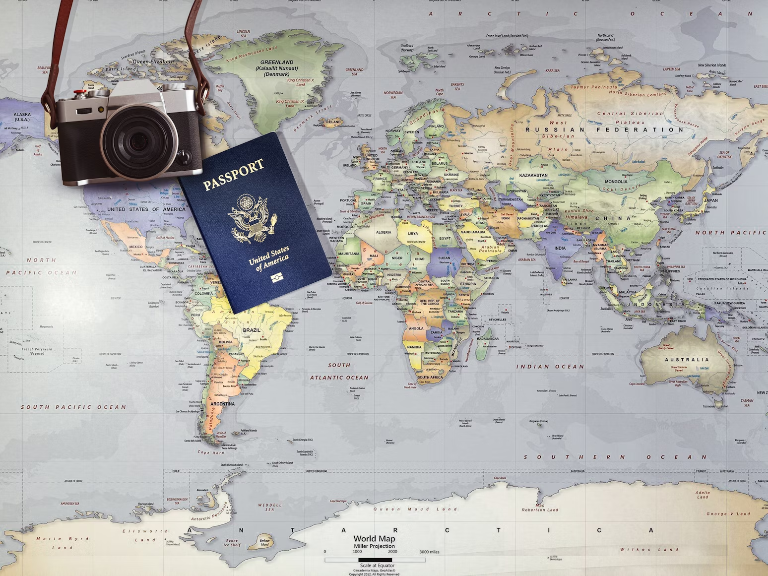 A passport and camera on a world map