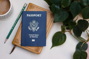 A passport next to a cup of coffee