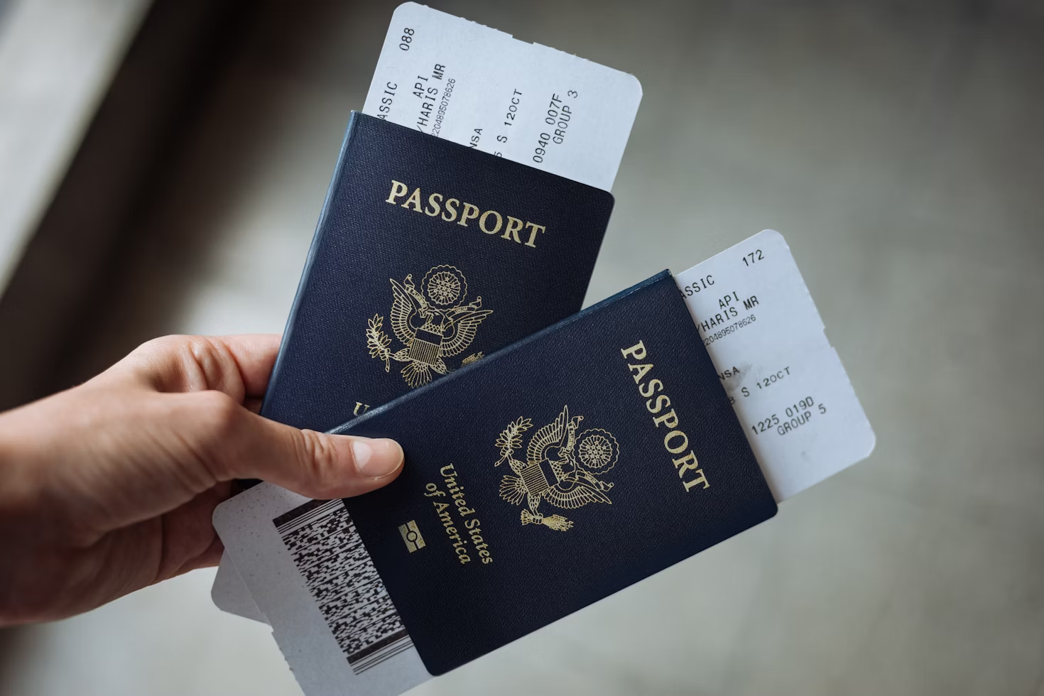 A person holding two passports 
